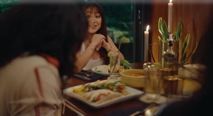 Dinner by candlelight, a woman laughing across the table
