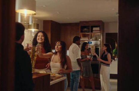 Friends crowding a warm kitchen